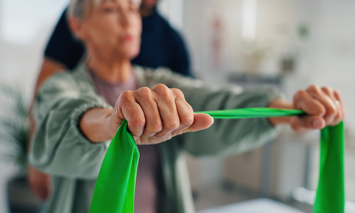 Physiotherapy, woman or hands with resistance band for rehabilitation, muscle exercise or body health. Mobility, client or stretching with elastic for fitness, physical recovery or help with balance